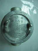 A round, metallic Eaton Crouse Hinds 0105235 cover with raised grips, safety warnings, UL/CSA marks, and engraved disconnect instructions, for explosion proof hazardous location conduit outlet boxes. Made in USA.