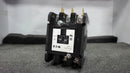 A black and white Eaton contactor (CONTACTOR | EATON | C25FNF360) stands upright on a gray foam surface, showing three brass terminal connectors on top.